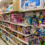 Regal mit verschiedenen Spielzeugen, Puppen und Bastelsets